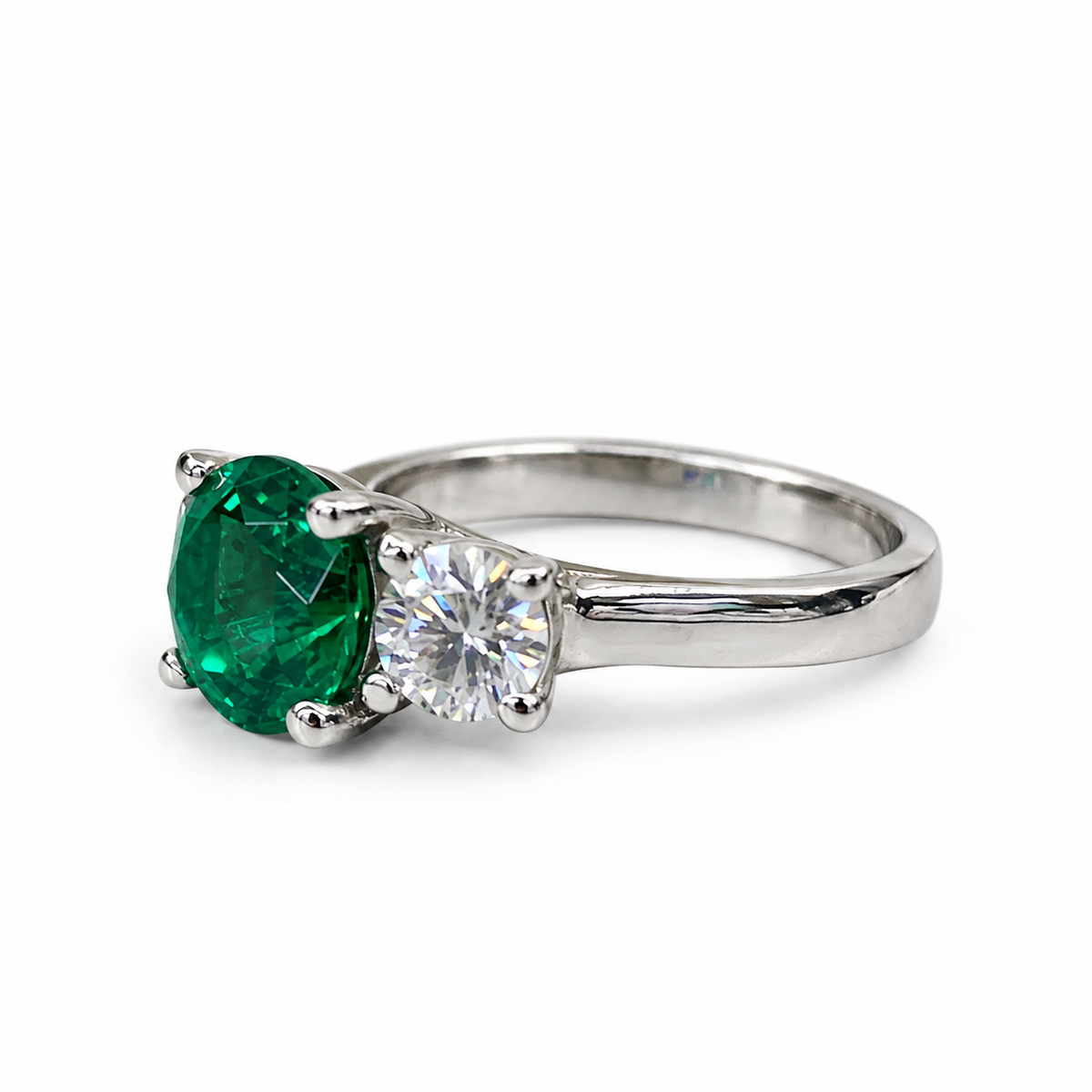 Emerald And Moissanite Round Three Stone Engagement Ring Set In 14K White Gold