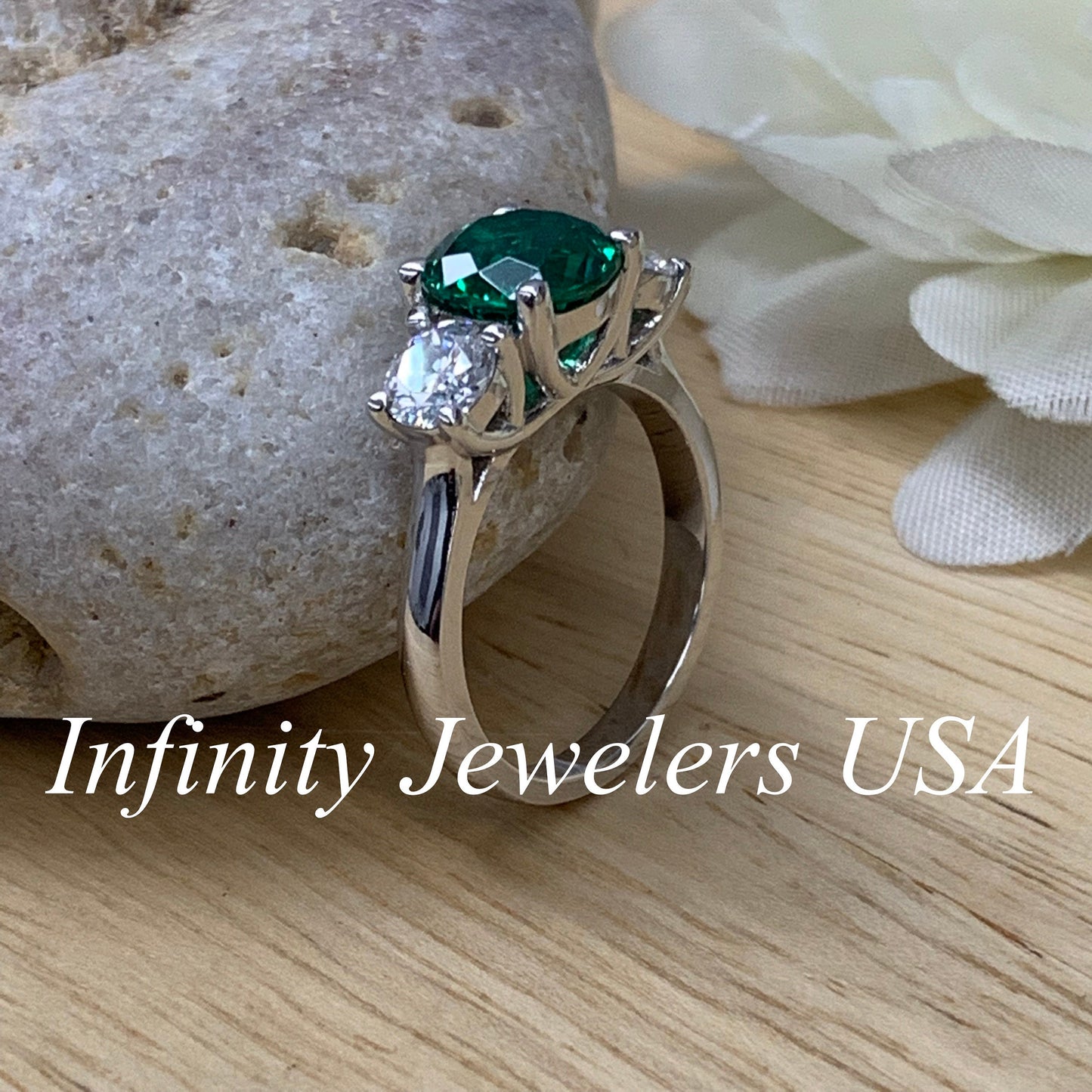 Emerald And Moissanite Round Three Stone Engagement Ring Set In 14K White Gold
