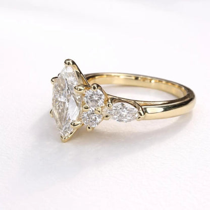 A close-up view of a gold engagement ring with a large diamond set in the center, surrounded by smaller diamonds.