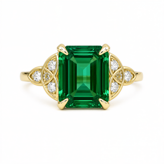 A gold ring with a large, square-cut green gemstone at the center, surrounded by smaller diamonds.