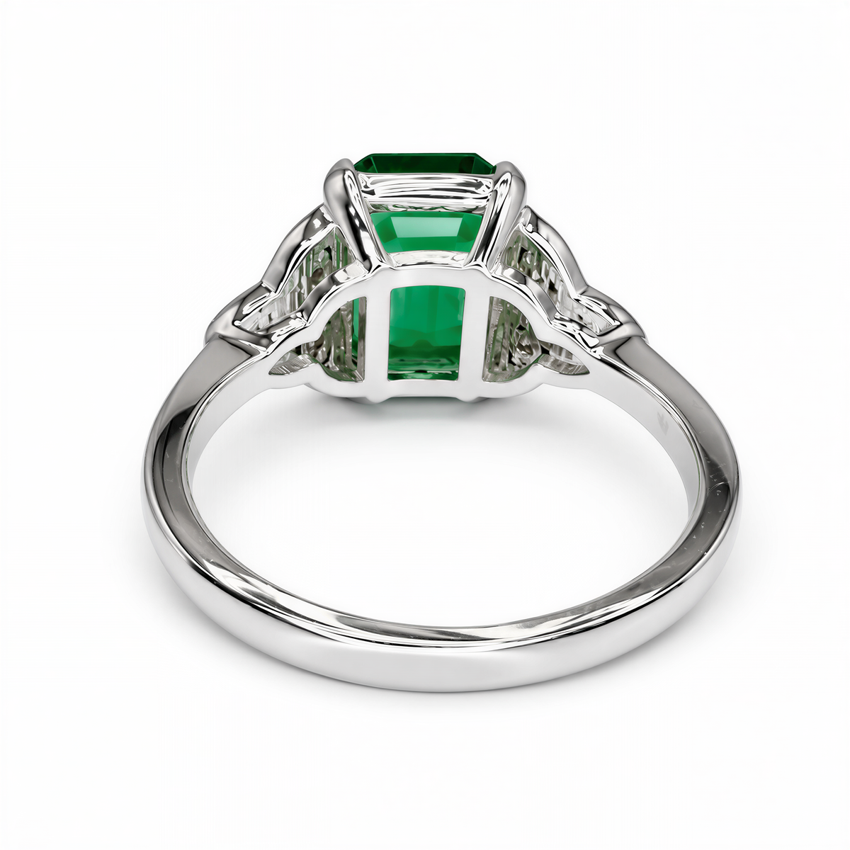 A silver ring with a large, green gemstone set in the center.