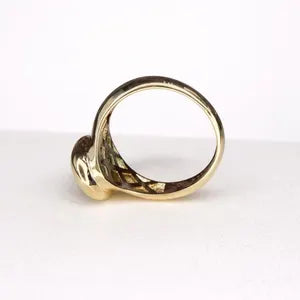 A gold ring with a unique, twisted design is shown against a white background.