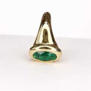 A gold ring with a large oval-shaped green gemstone in the center.