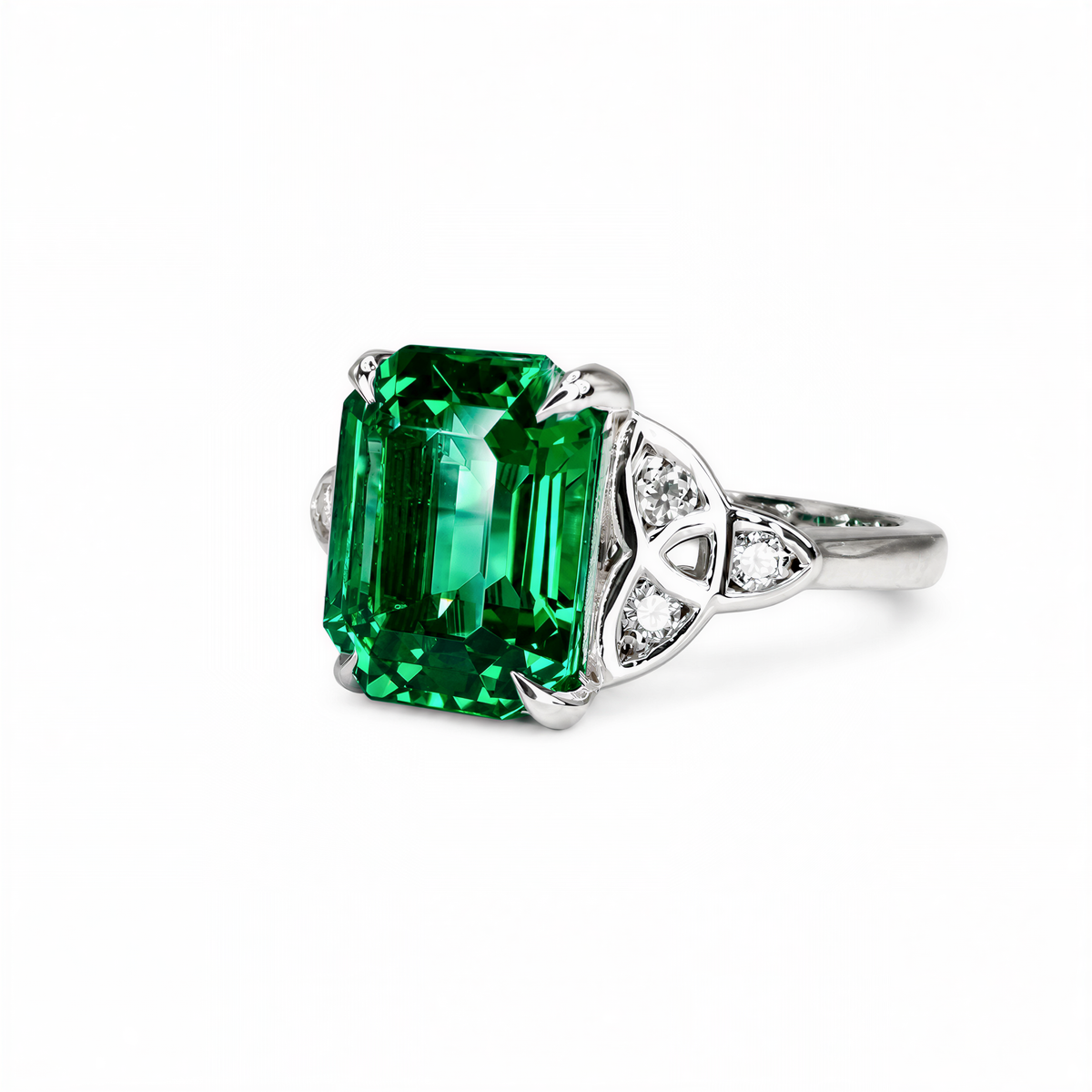 A stunning ring featuring a large, vibrant green gemstone set in a silver band, with smaller diamonds adorning the sides.