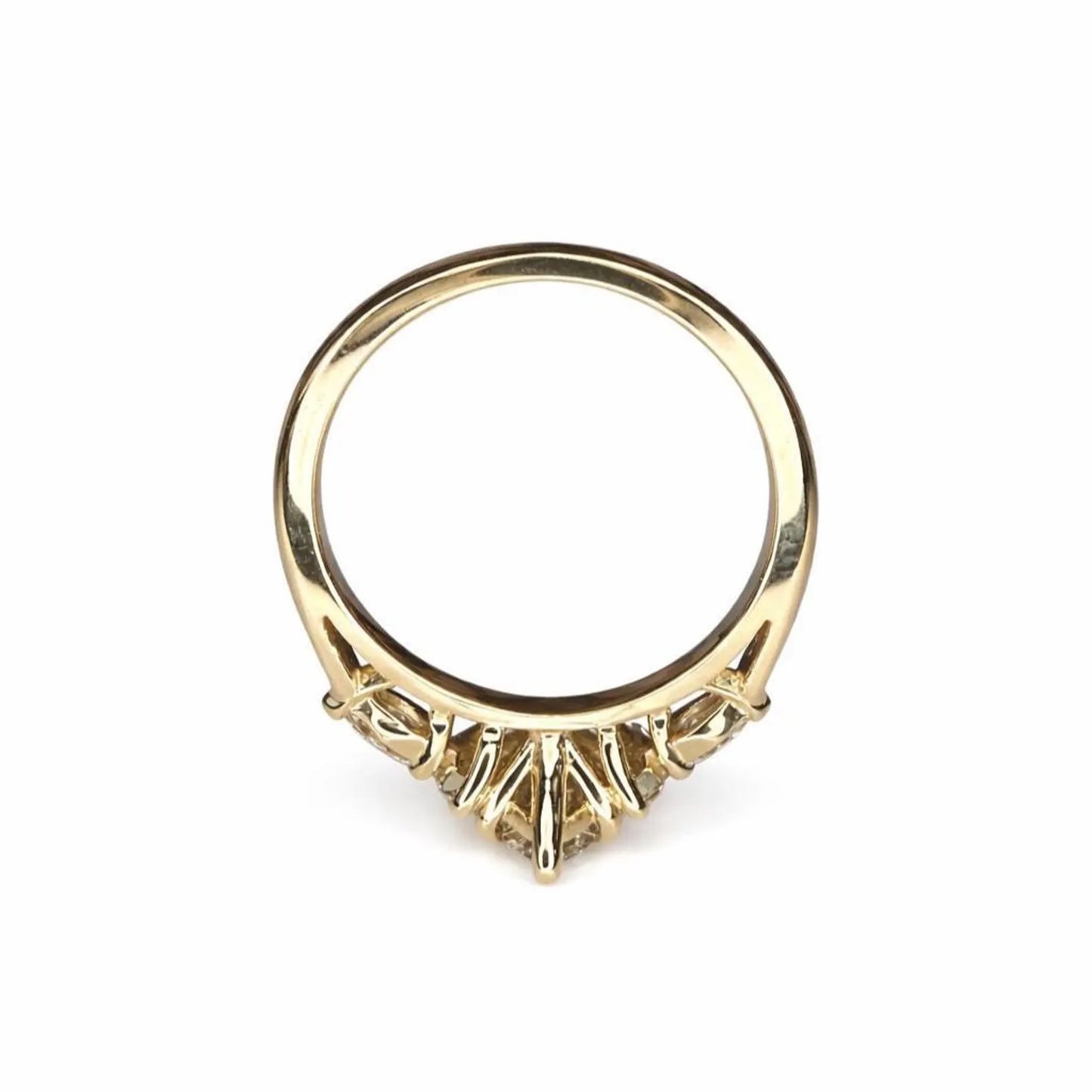 A gold ring with a large central diamond and smaller diamonds on either side.