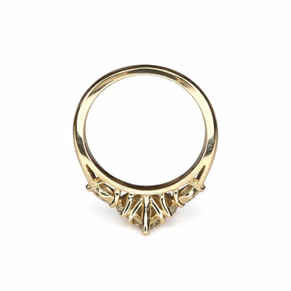 A gold ring with a large central diamond and smaller diamonds on either side.