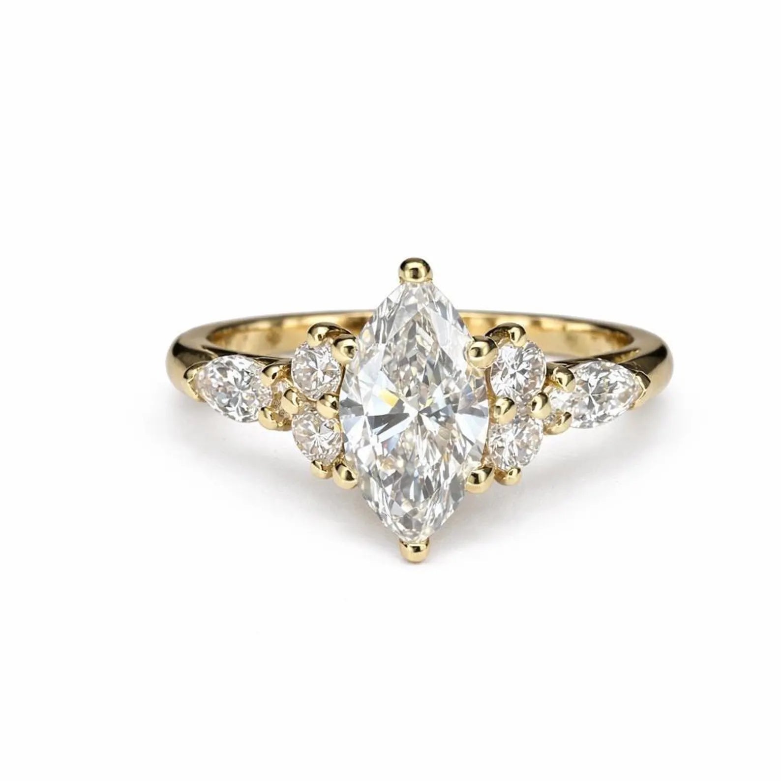 A gold engagement ring with a large central diamond surrounded by smaller diamonds on either side.