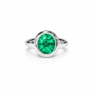A silver ring with a large, bright green gemstone set in the center.