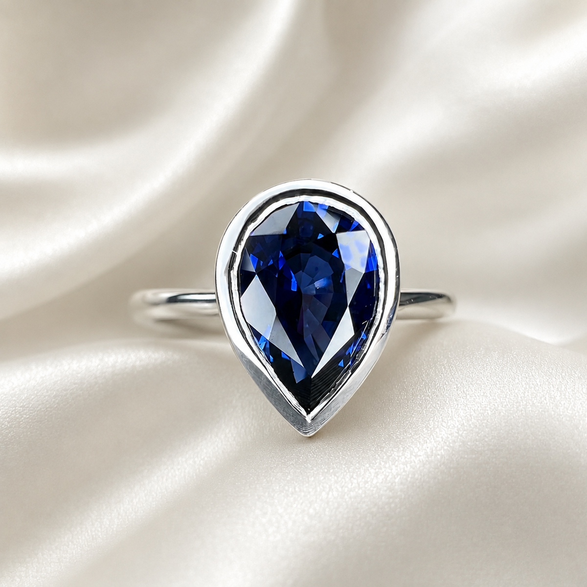 Pear shape  blue sapphire ladies ring, bezel set in 14k white gold #5860