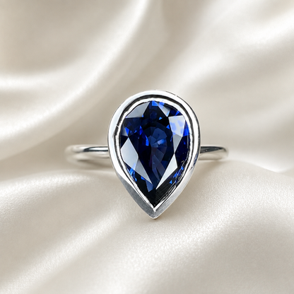 Pear shape  blue sapphire ladies ring, bezel set in 14k white gold #5860