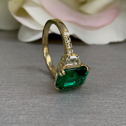 Emerald cut green emerald with trapezoid sides and round accents engagement ring, 4.50ctw, 14k yellow gold #6103