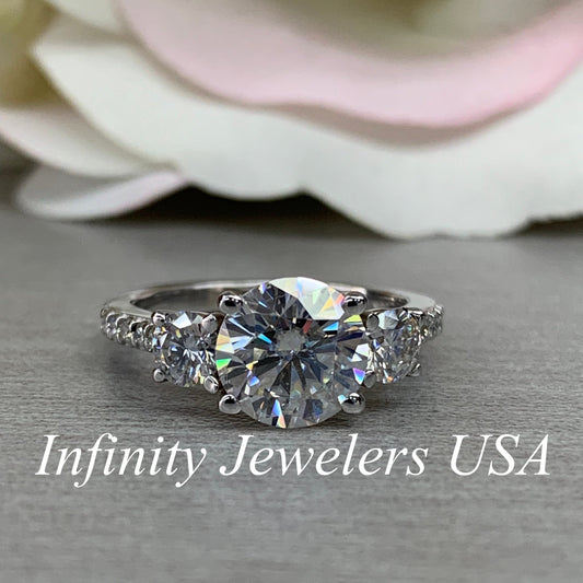 Certified Moissanite Three Stone Round Brilliant Cut Engagement Ring With Round Accents In 14K White Gold