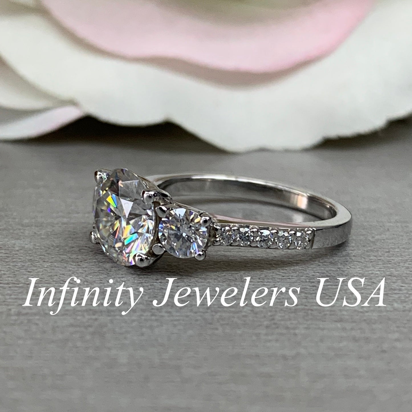 Certified Moissanite Three Stone Round Brilliant Cut Engagement Ring With Round Accents In 14K White Gold