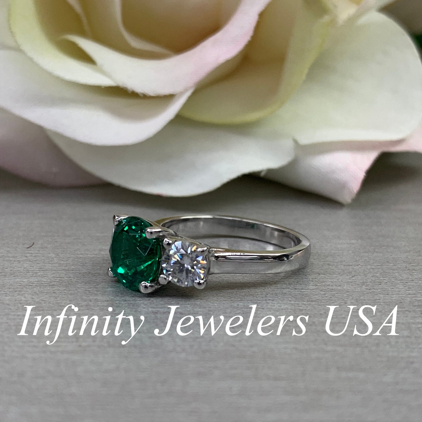 Emerald And Moissanite Round Three Stone Engagement Ring Set In 14K White Gold