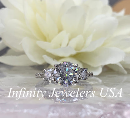 Certified Moissanite Three Stone Round Brilliant Cut Engagement Ring With Round Accents In 14K White Gold