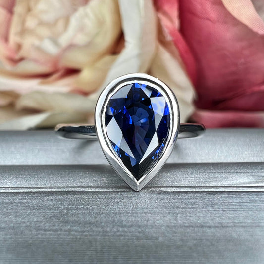 Pear shape  blue sapphire ladies ring, bezel set in 14k white gold #5860