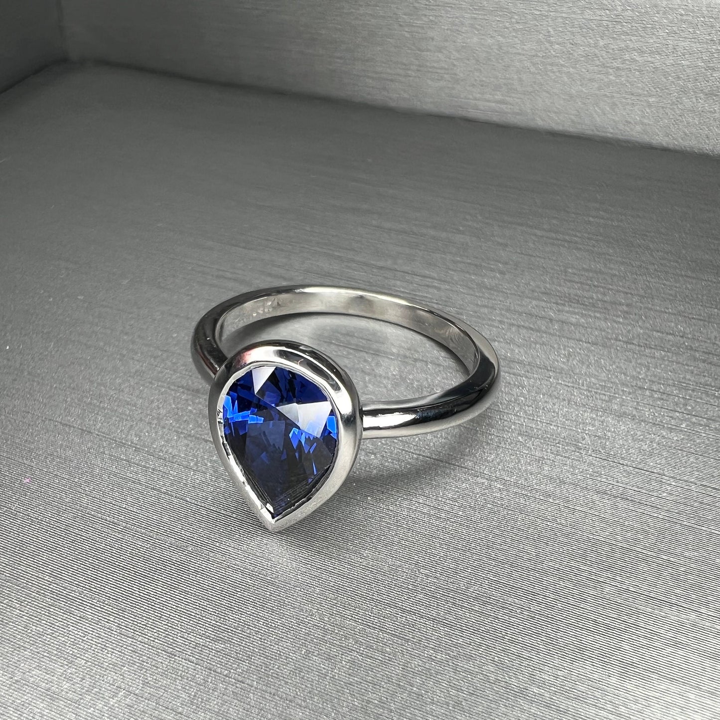 Pear shape  blue sapphire ladies ring, bezel set in 14k white gold #5860